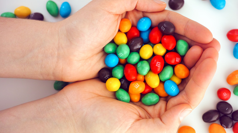 A woman holding M&M's in her hands