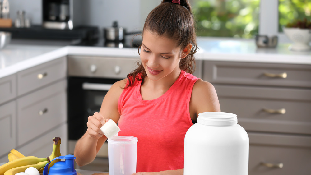 woman preparing a protein shake