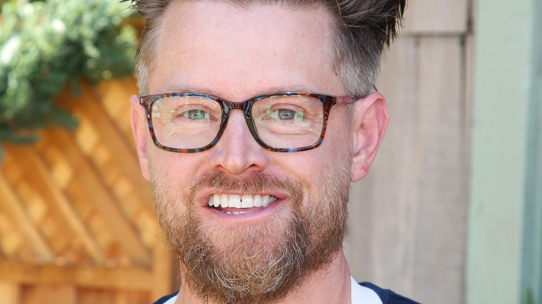 Chef Richard Blais smiles with glasses and a beard