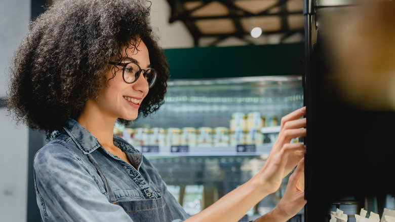 Woman smiling at vending machine