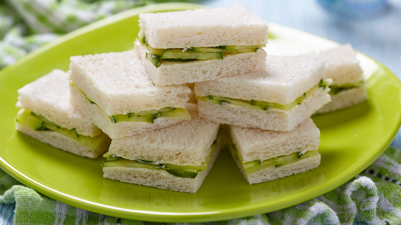 cucumber sandwiches on green plate