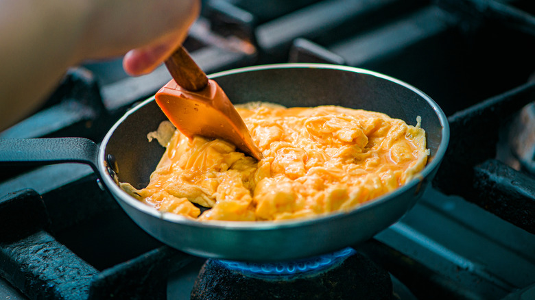 Scrambled eggs being cooked in pan