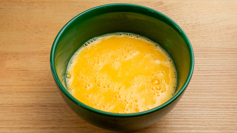Bowl of raw beaten eggs