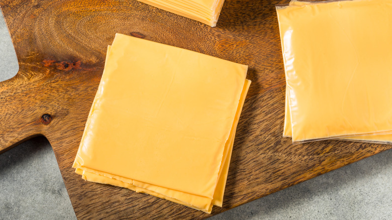 American cheese slices on cutting board