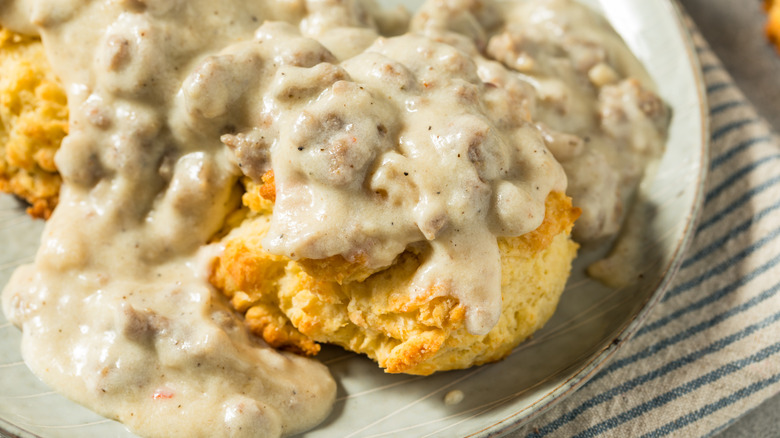 Biscuits and gravy on plate.