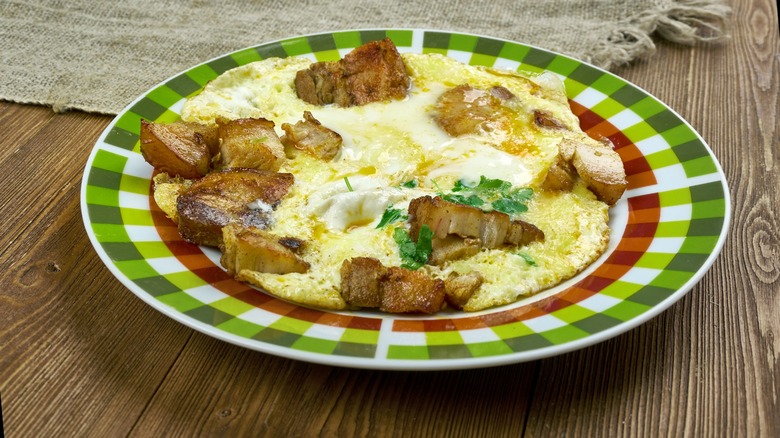 a dish of Hangtown Fry on wooden table