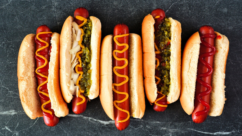 Hot dogs with toppings on buns