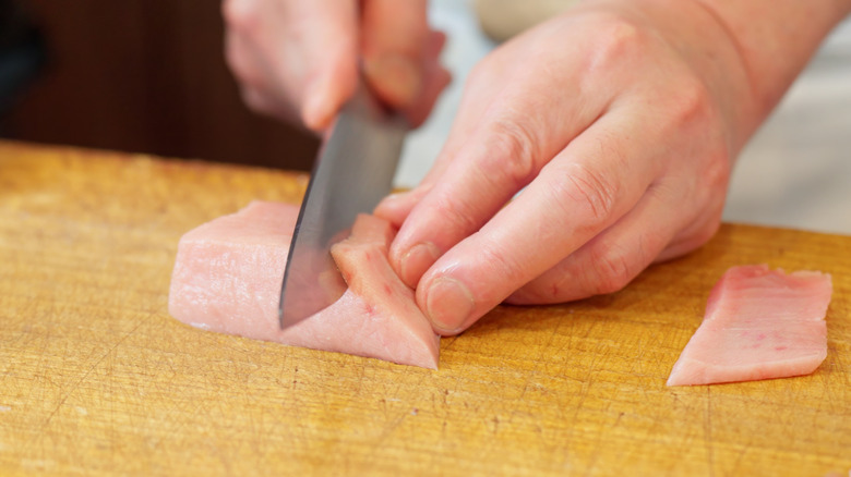 Chef cutting swordfish