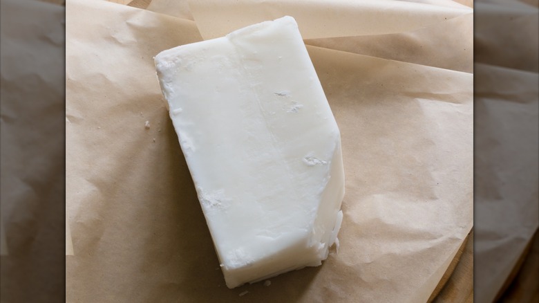 Solid rectangle of beef tallow on brown paper