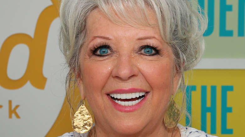 Paula Deen smiling wearing earrings