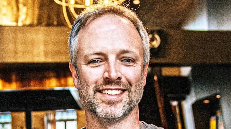 Chef William Dissen holding vegetables