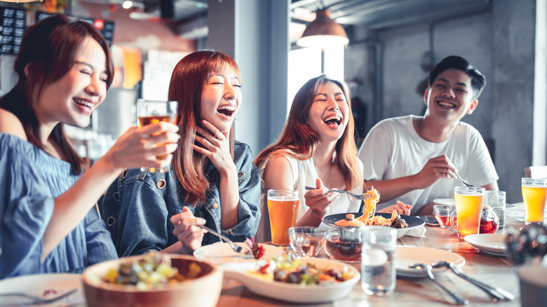 People dining out and laughing