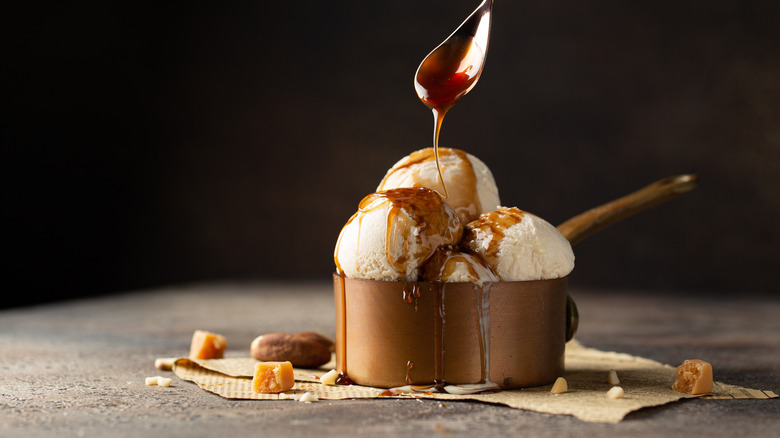 Ice cream being drizzled with caramel