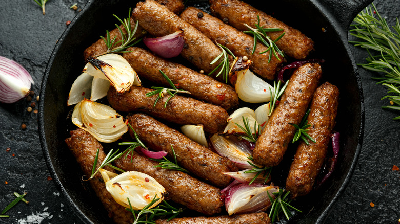 Sausages in a pan with herbs
