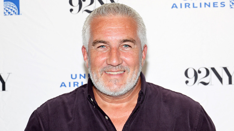 Closeup of Paul Hollywood smiling on step-and-repeat