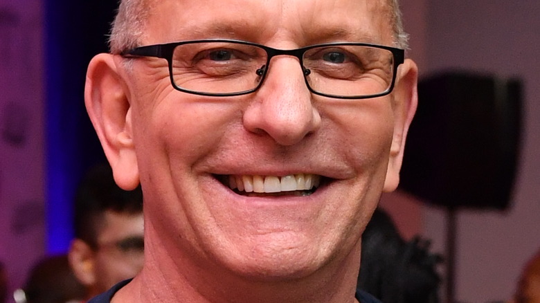 Robert Irvine with wide smile and glasses