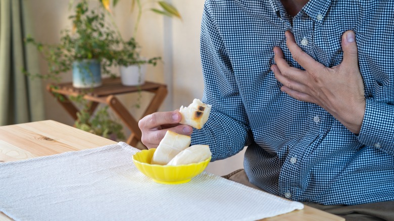 Man coughing while eating