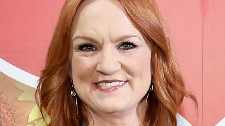 Ree Drummond standing with sign