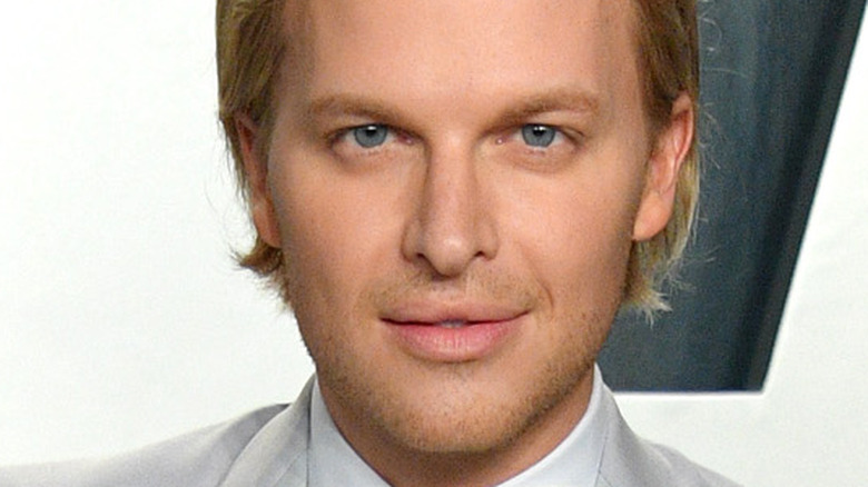 Ronan Farrow smiling in a silver tux