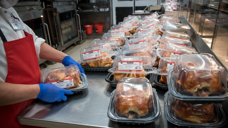 Employee packaging rotisserie chickens