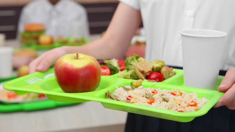 Child walking with lunch tray