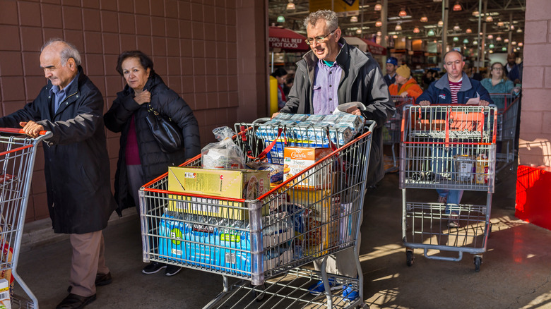 shoppers leaving Costco with carts