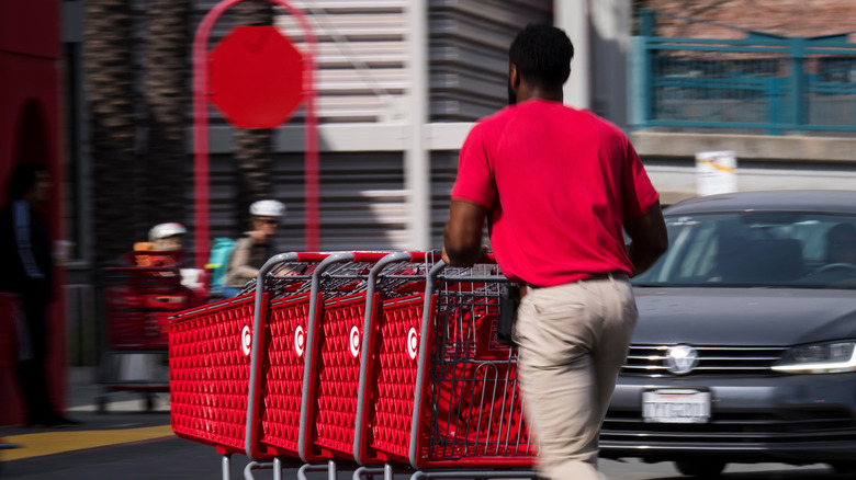Target employee pushing carts
