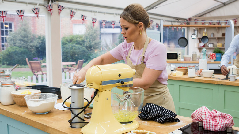 baking contestant working with mixer