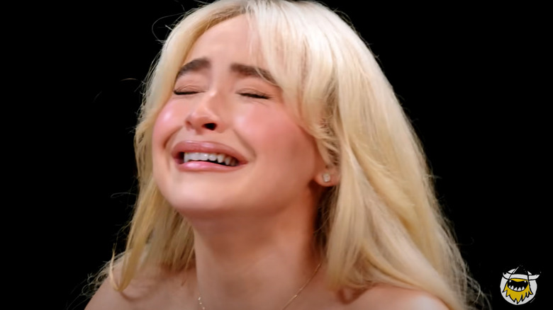 Sabrina Carpenter on "Hot Ones" making a pained face