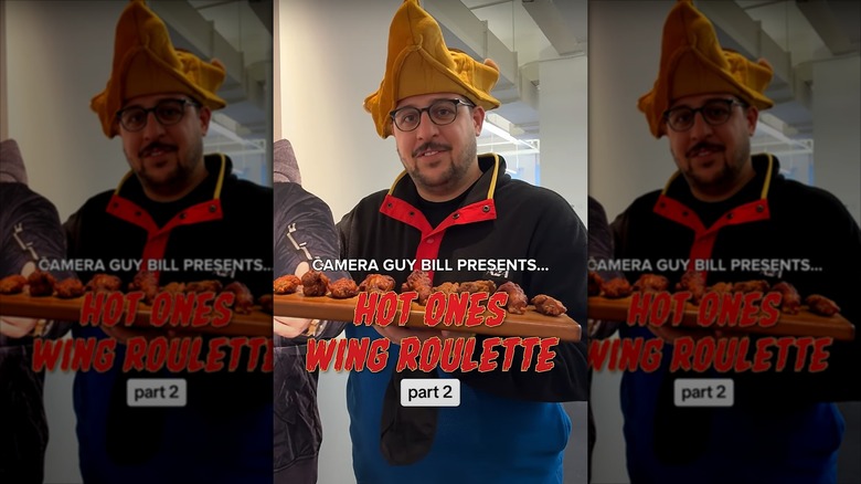 camera guy holding a plate of wings