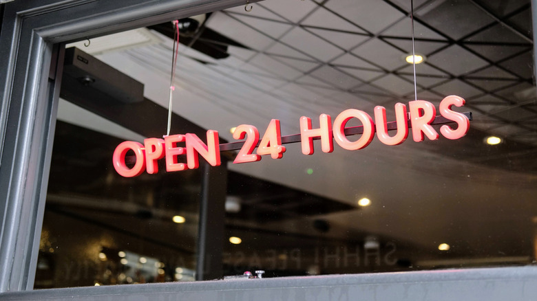 neon sign saying "open 24 hours"