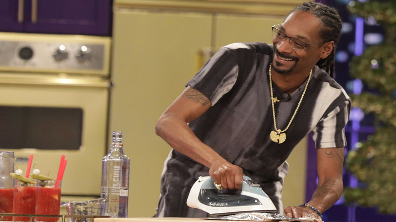 Snoop Dogg heating up food with clothes iron on set of Potluck Dinner Party