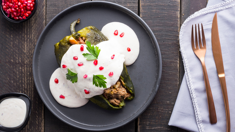 Plate of chiles en nogada with cutlery