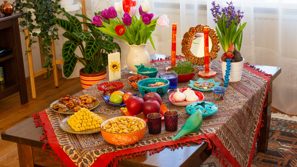 Haft Sin table with flowers and candles