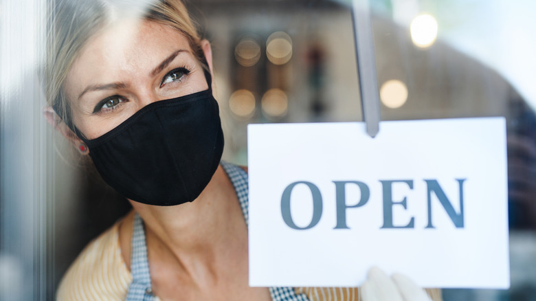 A woman at a retaurant wearing a mask