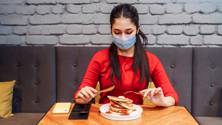 A diner wearing a face mask