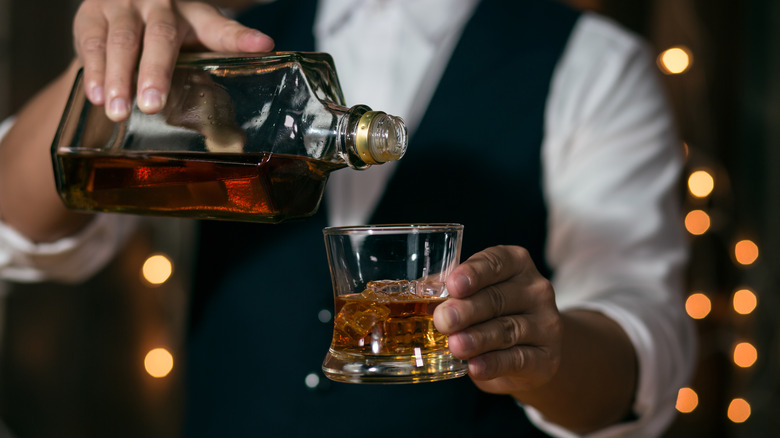 Barman pouring whiskey