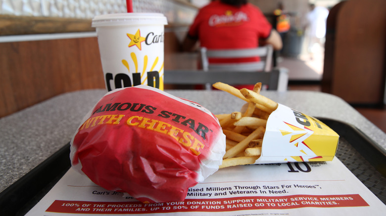 A Carl's Jr. Famous Star burger with fries and a soda