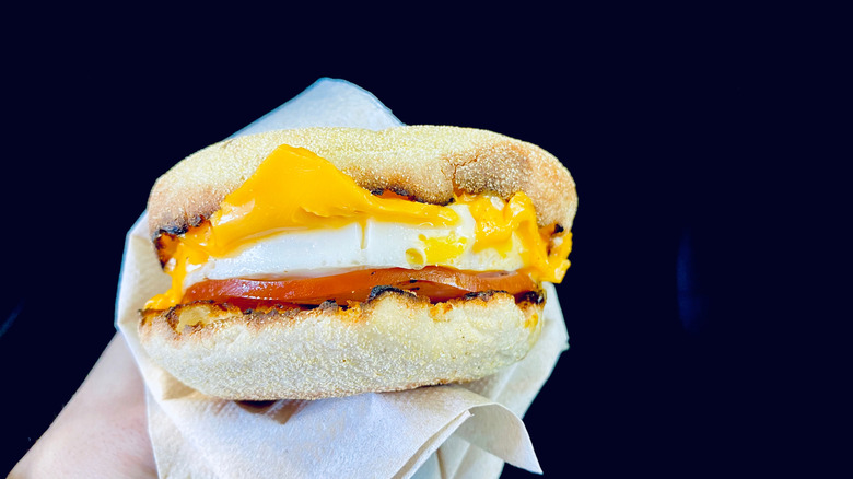 Hand holding an Egg McMuffin