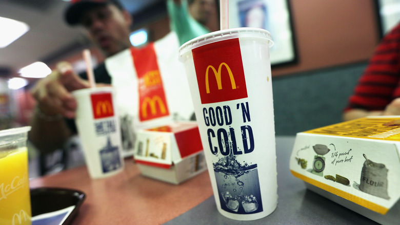 McDonald's fountain soda cup on a table with other food items