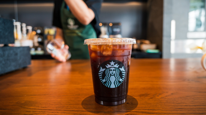 Starbucks product placed before worker