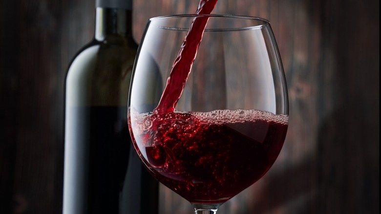 Wine glass with bottle and red wine 
