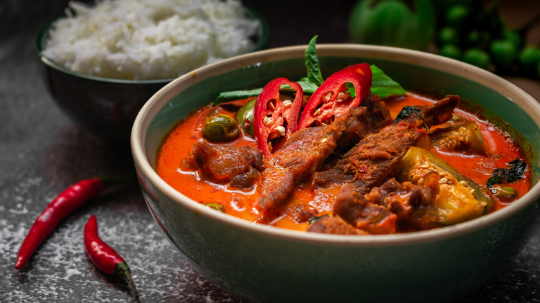 bowl of spicy curry with chilis