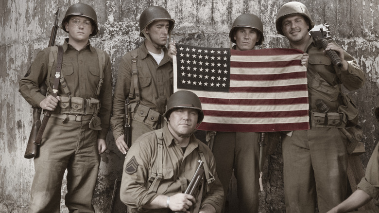 WWII American soldiers holding the American flag