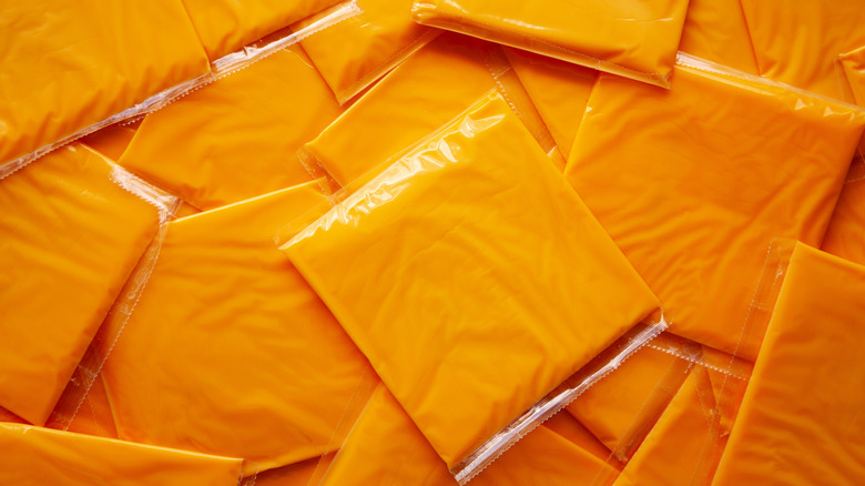 Slices of processed American cheese in wrappers