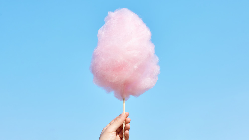 Food dye represented in the form of  pink, fluffy cotton candy which often has dye