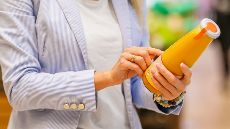 woman looking at a food label