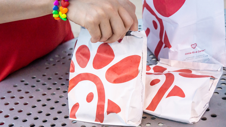 Hand holding Chick-fil-A bag