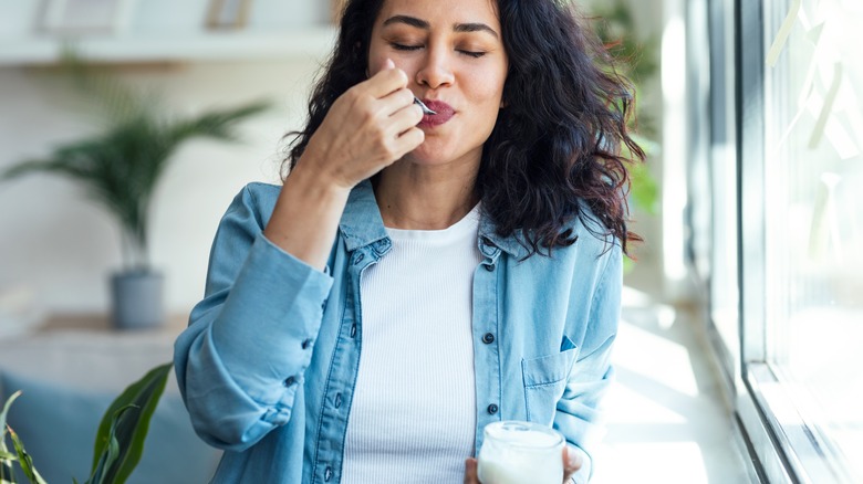 person eating yogurt