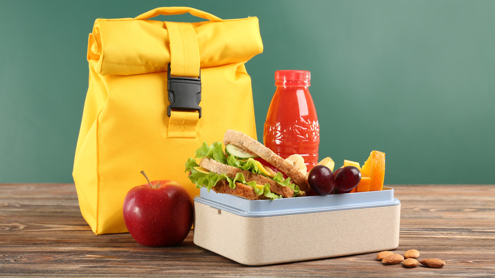 Yellow lunch sack with a lunch box with healthy food